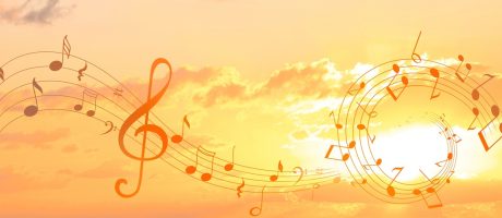 Treble,Clef,And,Swirly,Staff,With,Musical,Notes,Against,Sunset